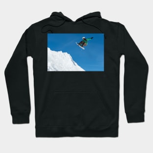 Snowboarder jumping against blue sky Hoodie